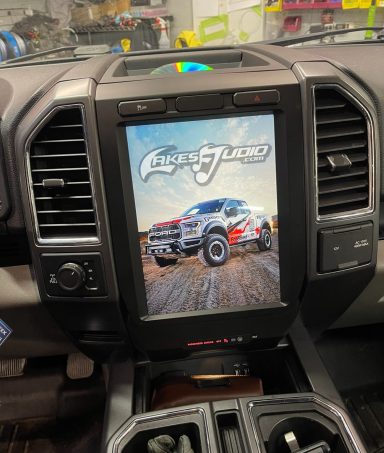 Dashboard display of a vehicle showing a car-themed digital interface.