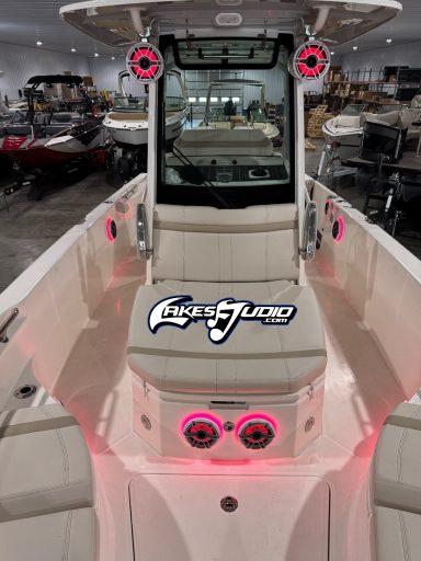 White boat interior with a central console, pink accents, and a logo.